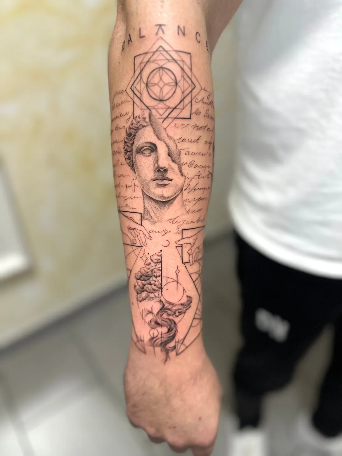 Statue mit Geometrie und Schriftzug Balance — Fine Line Tattoo von Marko